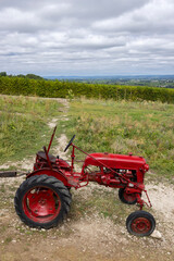 Fototapeta premium Red tractor near Monbazillac castle (Chateau de Monbazillac), Dordogne department, Aquitaine, France