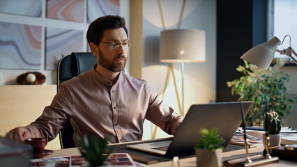 Entrepreneur looking laptop screen working office close up. Man drinking coffee.