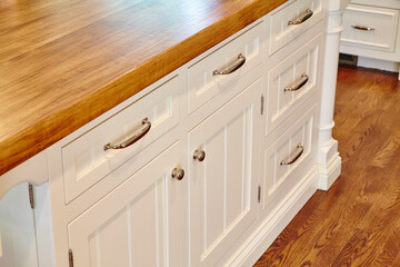 Elegant White Kitchen Cabinets with Wood Countertop and Dark Floor