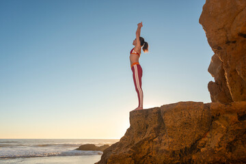 female swimmer, surfer doing stretching exercise in preperation