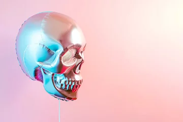 Abwaschbare Fototapete Skull shaped helium balloon. Inflatable balloon in a shape of human skull on pastel background. Halloween party, skeleton jokes and congratulations. Greeting card. Copy space for text © Magryt