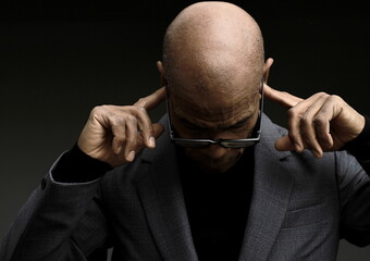 deafness suffering from hearing loss on grey black background with people stock image stock photo	