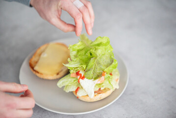 Delicious healthy sandwich for a snack breakfast in men's hands. Toast bread tomato ham leaf salad