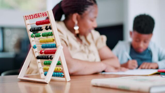Grandmother, boy kid and writing homework with notebook, studying and thinking with abacus for development. Woman, school child and family home with scholarship, education and learning in apartment