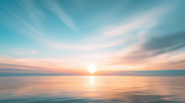 A serene image capturing the sun setting over a still ocean, with a beautifully streaked sky in pastel hues.