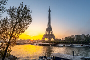 Fototapeta na wymiar Eiffel Tower, French: Tour Eiffel, silhouette at sunrise time on sunny day. View from Seine River. Paris, France