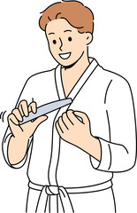 Man uses nail file after shower, performing daily hygiene and SPA procedures to take care of skin