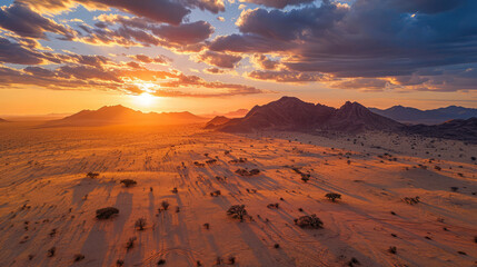 Fototapeta na wymiar aerial sunrise with shadows over desert terrain.
