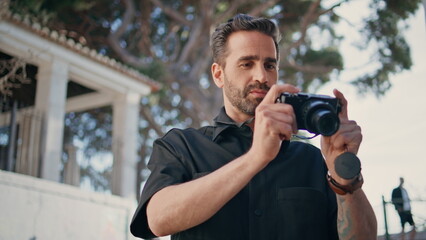 Tourist guy taking photos professional camera closeup. Italian man make pictures