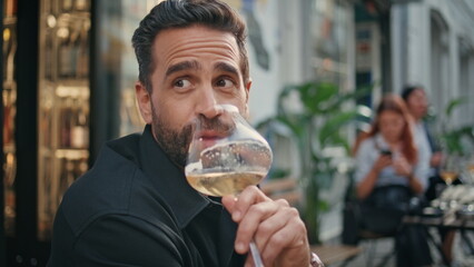 Man model enjoying alcohol summer cafe bar close up. Guy drinking wine portrait