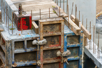Building foundation construction. Monolithic concrete and reinforced concrete structures on the construction site. The use of metal formwork and fittings in construction.