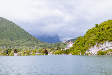 Fototapeta na wymiar Scenic Lake Annecy beautiful mountains and coast - (French: Lac d'Annecy)