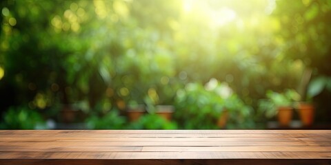 Wooden table with a blurred green backyard for an ad template.