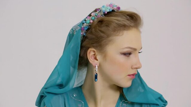 Profile of woman look aside in dress with hood and diadem on head