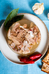 Jelly with meat, beef aspic, traditional dish. portion on plate. Bread and chili.