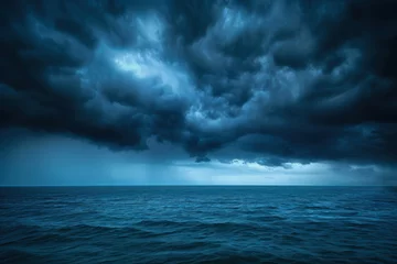 Foto op Canvas Storm clouds over the sea are black and blue. A hurricane is coming a downpour. Natural sinister background. Storm warning. Weather disasters. The sea is a gloomy landscape. Blue abstract background © Roman