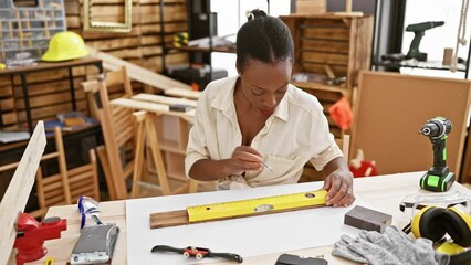 Beautiful african american woman carpenter measuring wood plank, a glimpse into carpentry and construction industry - Powered by Adobe
