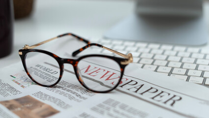 glasses on the newspaper
