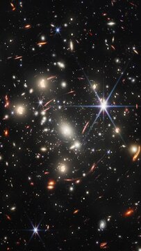 Deep space travel to far away galaxies. Part of the first image from NASA's James Webb Space Telescope has been used. CREDITS: NASA, ESA, CSA, and STScI. Vertical design for smartphone. 