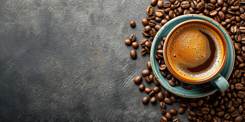Mug with hot and delicious coffee and coffee beans on a concrete background. Overhead view with copy space.