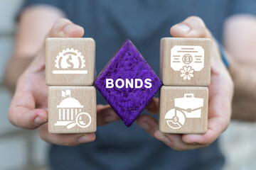 Man holding blocks sees word: BONDS. Bonds investment Business Finance concept. Corporate Bond Banking Market Management.