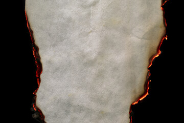 burning paper, glowing edge of paper on a black background