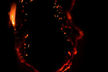 burning paper, glowing edge of paper on a black background