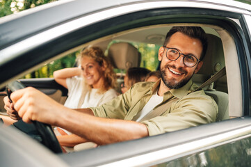 Portrait of a father enjoying road trip on weekend and traveling with his family