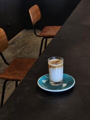 Nice layer of Coffee latte on wooden table in vintage cafe - 718390351