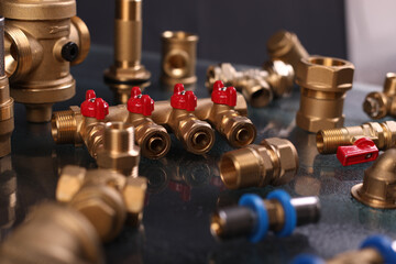 A set of metal and copper water pipe parts, a water wrench and pipe elbows, blue and red colors,...