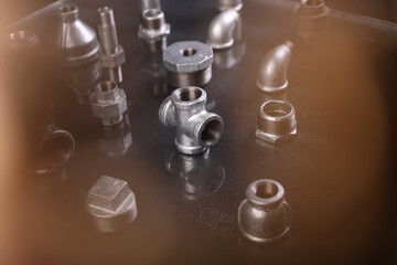 A set of metal and copper water pipe parts, a water wrench and pipe elbows, blue and red colors,...