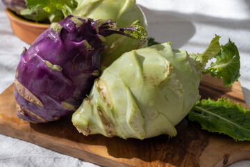 Heads of fresh ripe bio white and purple cabbage kohlrabi from organic farm, close up