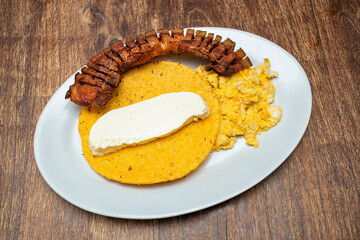 Traditional Colombian breakfast - Arepa, chicharron, cheese and fried egg