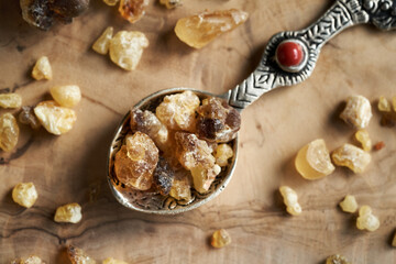 Frankincense resin crystals on a spoon, close up