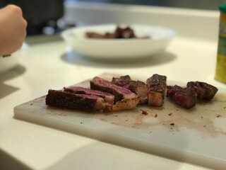 pieces of beef steak on a cutting board
