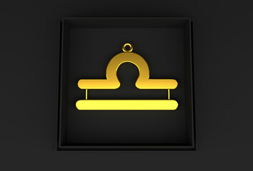 A golden Libra zodiac pendant rests in an elegant black box against a black background, exuding...