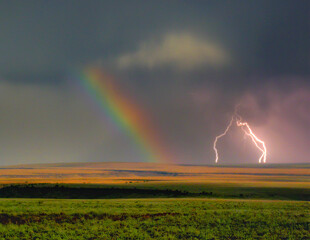 An extremely rare weather event resulted in a rainbow made by a full moon while lightening flashed...