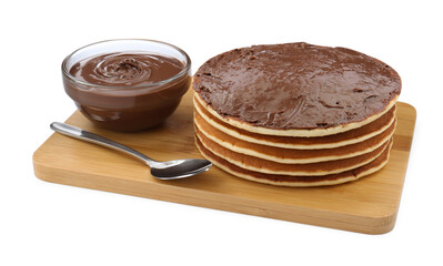 Tasty pancakes with chocolate paste and spoon isolated on white
