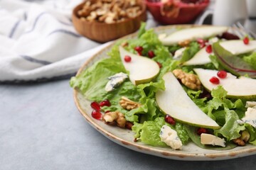 Delicious pear salad on grey textured table, closeup. Space for text