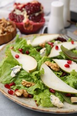 Delicious pear salad on grey table, closeup