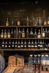 Blending process of cognac spirit and old French oak barrels in cellar in old distillery in Cognac...