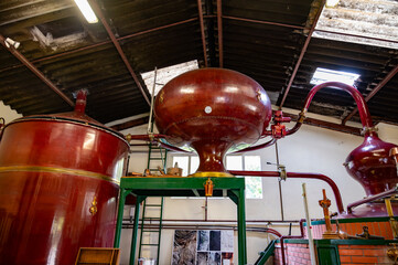 Double distillation process of cognac spirit in Charentias copper still pots and boilers in...