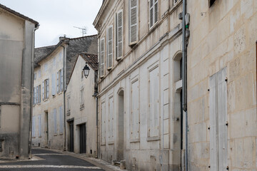 View on old streets and houses in Cognac white wine region, Charente, walking in town Cognac with strong spirits distillation industry, France