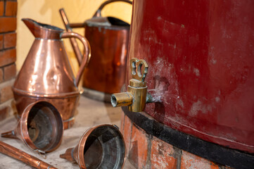 Double distillation process of cognac spirit in Charentias copper still pots and boilers in...