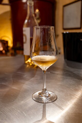 Tasting of cognac spirit aged in old French oak barrels in cellar in distillery in Cognac white wine region, Charente, Segonzac, Grand Champagne, France