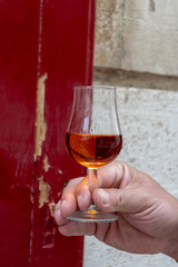 Tasting of cognac alcohol drink and view on old streets and houses in town Cognac, Grand Champagne,...