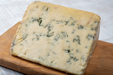 Cheese collection, English semi-soft, crumbly old stilton blue cheese close up