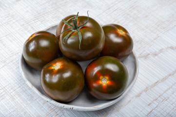Fototapeta na wymiar Fresh ripe sweet reddish brown and green kumato tomatoes