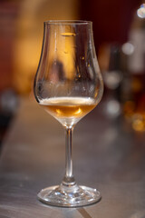 Tasting of cognac spirit aged in old French oak barrels in cellar in distillery in Cognac white wine region, Charente, Segonzac, Grand Champagne, France