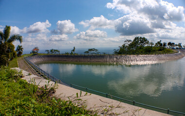 A reservoir on a hill which functions as irrigation as well as a refreshing place